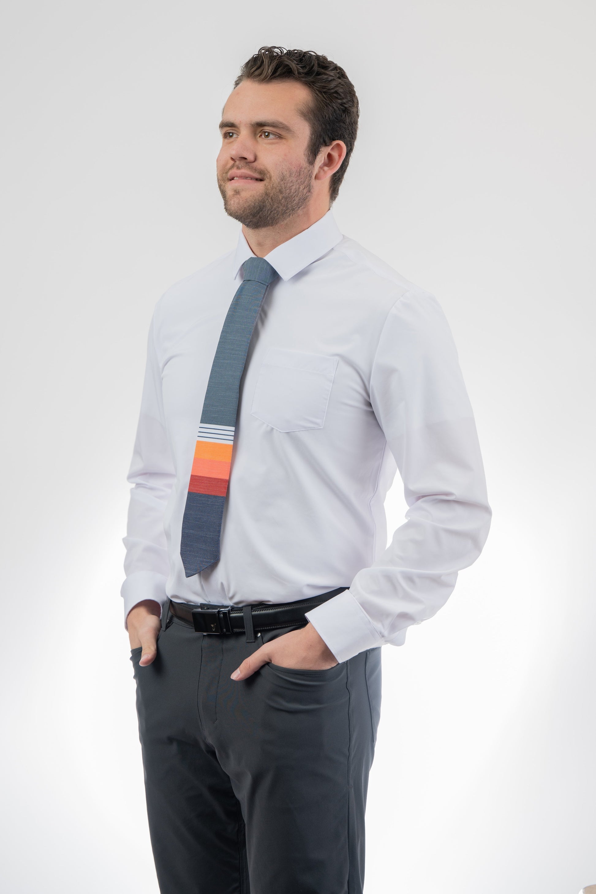 Man wearing a modern, colorful, cool necktie with thick, color blocked stripes of yellow, peach, and red