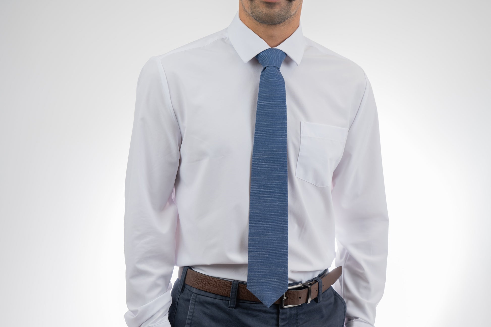 Man wearing a cool, modern, blue necktie. Sharp prom tie from Kator Shop in Logan, Utah — bold color and luxury texture for a standout prom night look.